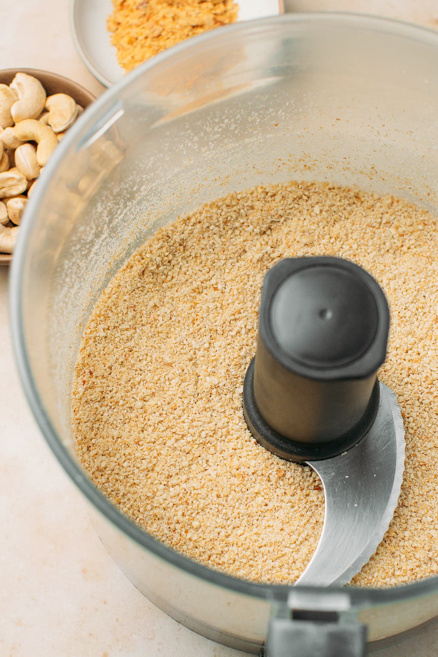 Processed cashews and nutritional yeast in a food processor.