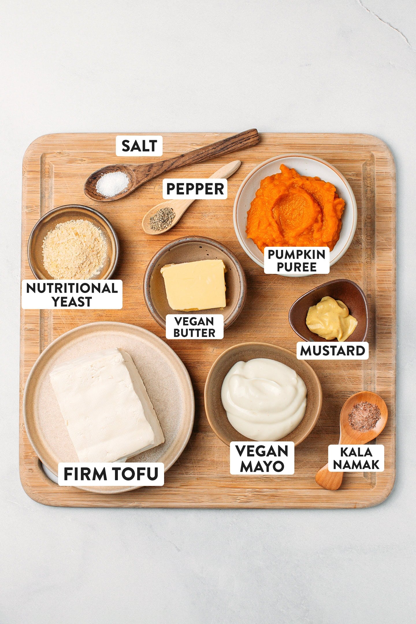Ingredients like pumpkin purée, firm tofu, mayo, nutritional yeast, butter, and mustard.