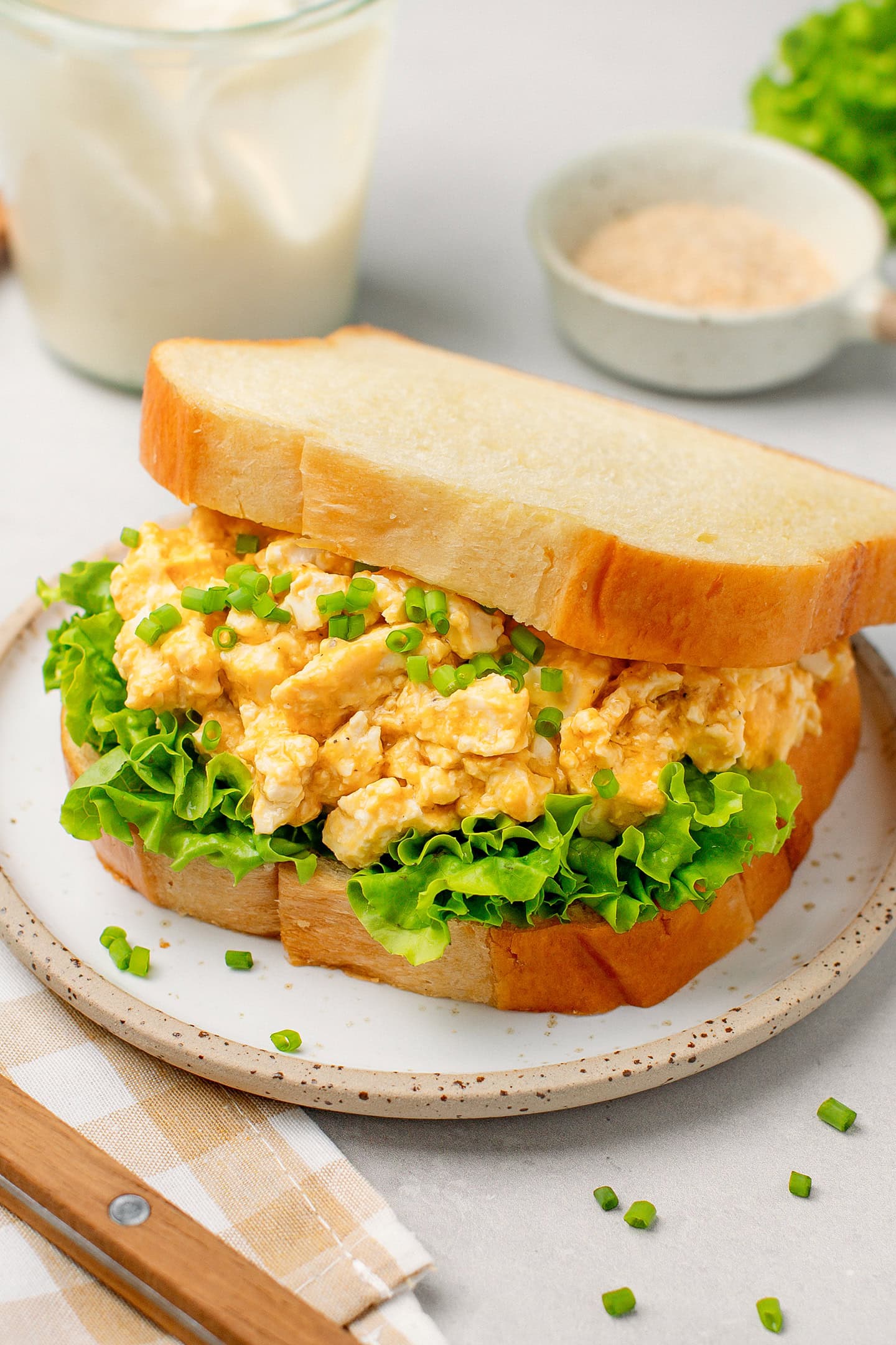 Sandwich filled with salad and vegan egg salad.