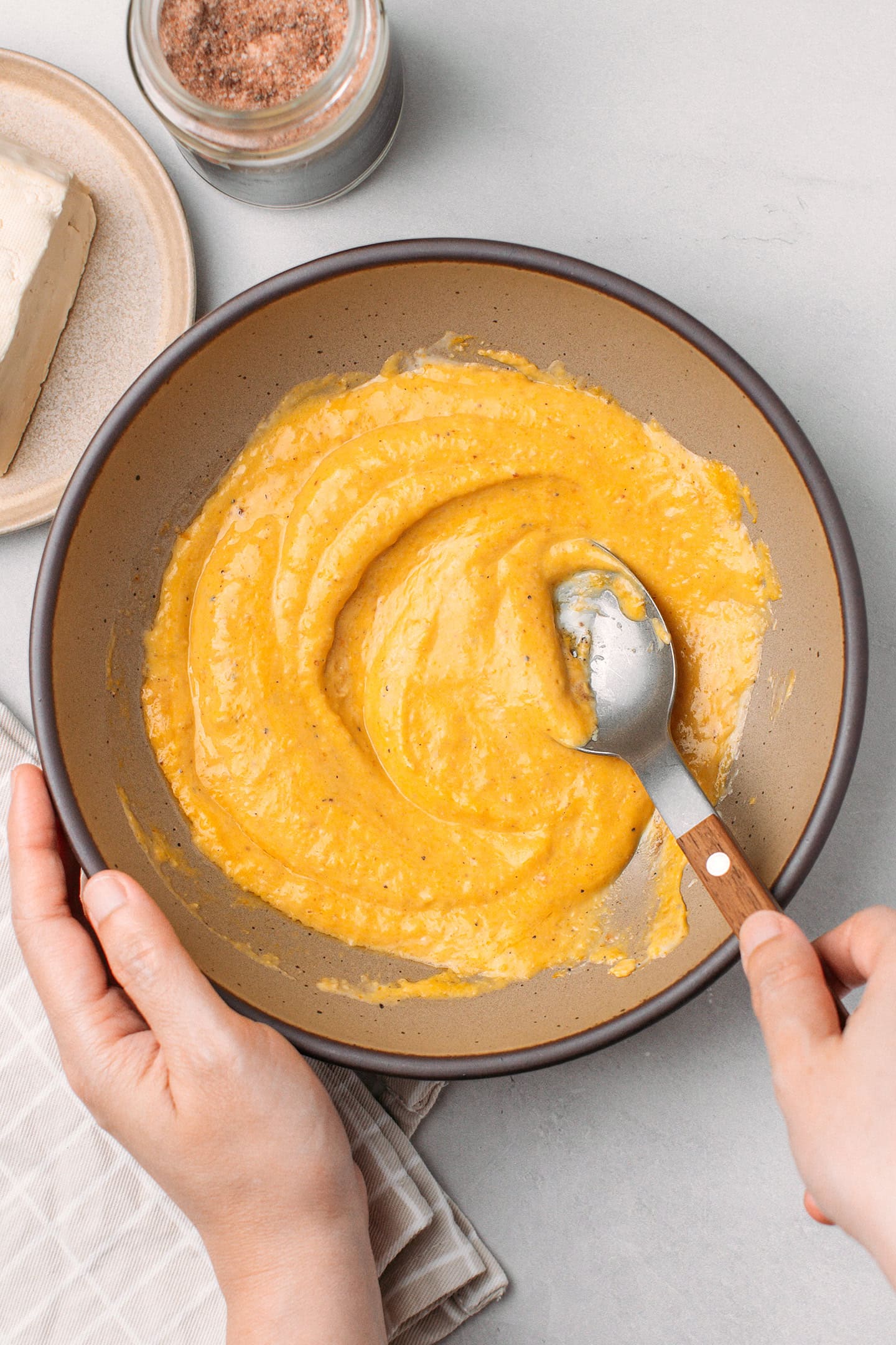 Mixing pumpkin puree and mayo in a bowl.