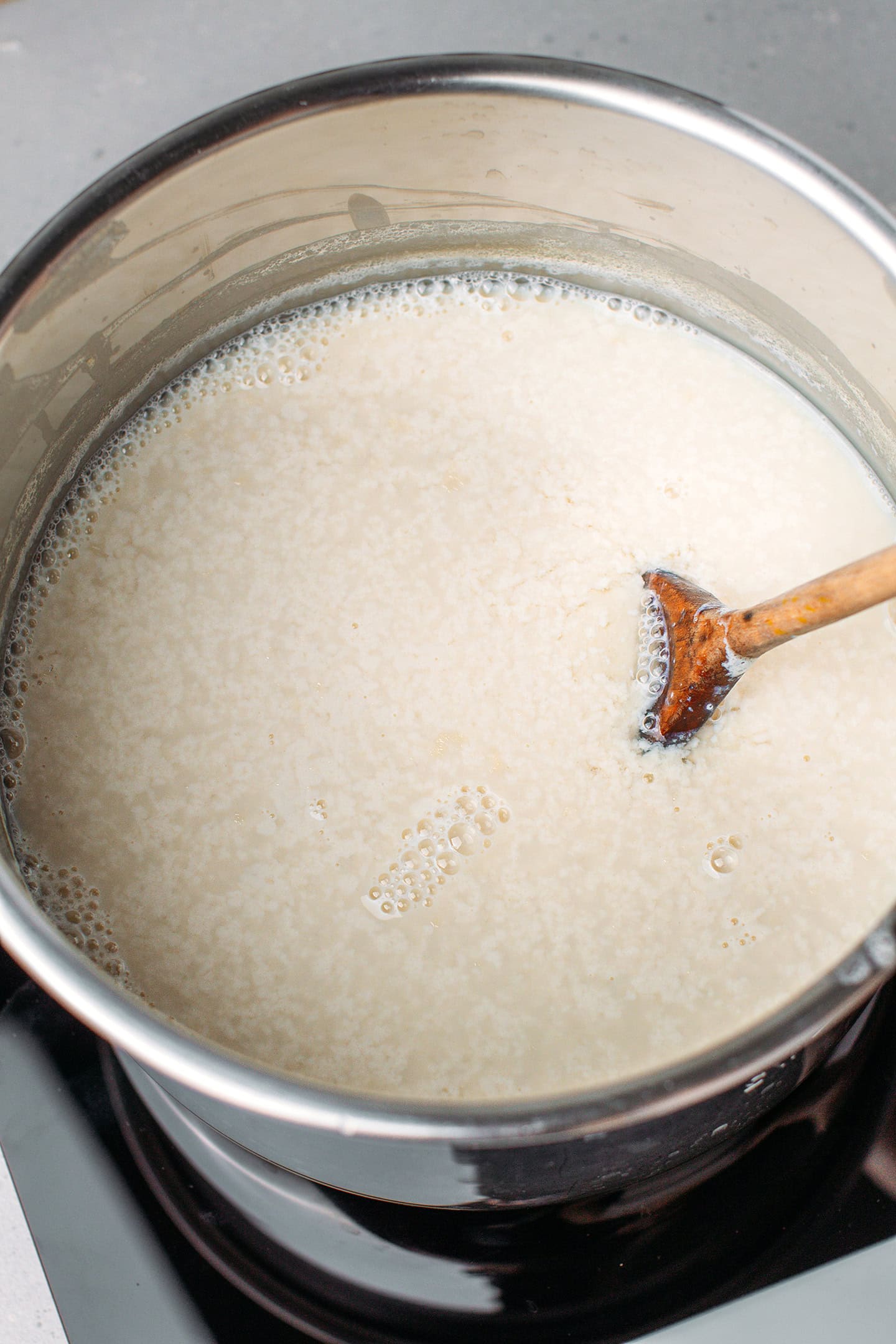 Close-up of curds and whey in a pot.