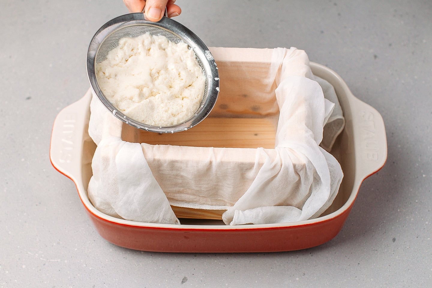 Transferring curds into a tofu press.