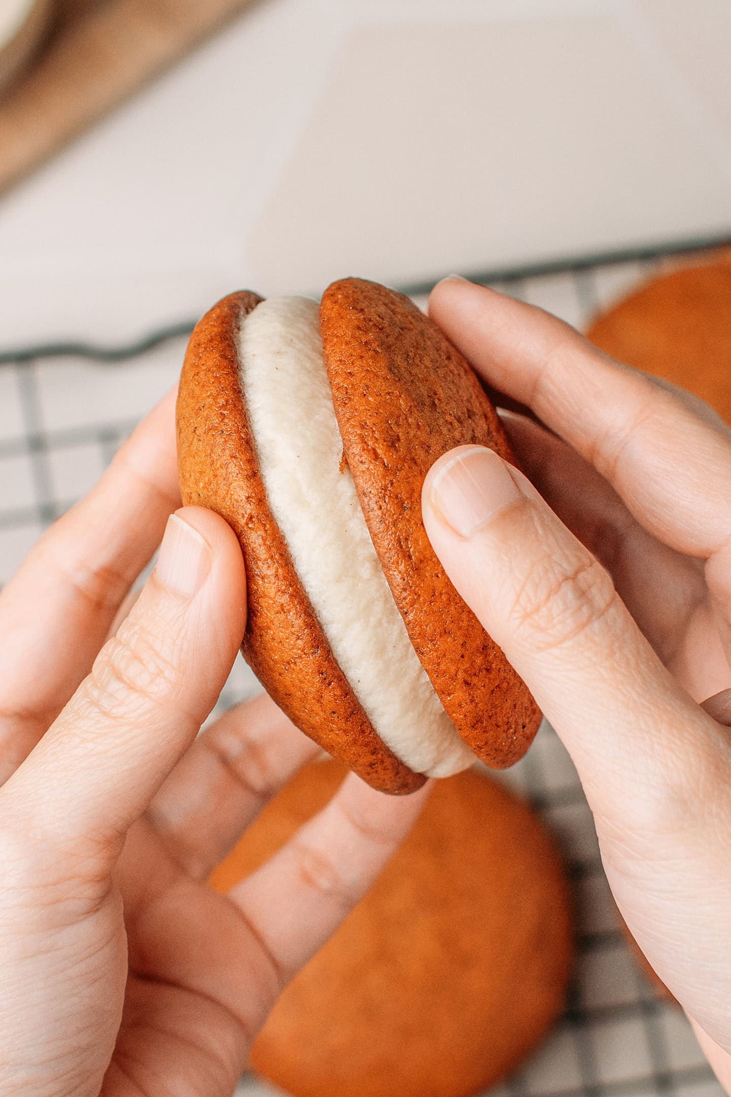 Sandwiching cashew cream between two pumpkin cakes.