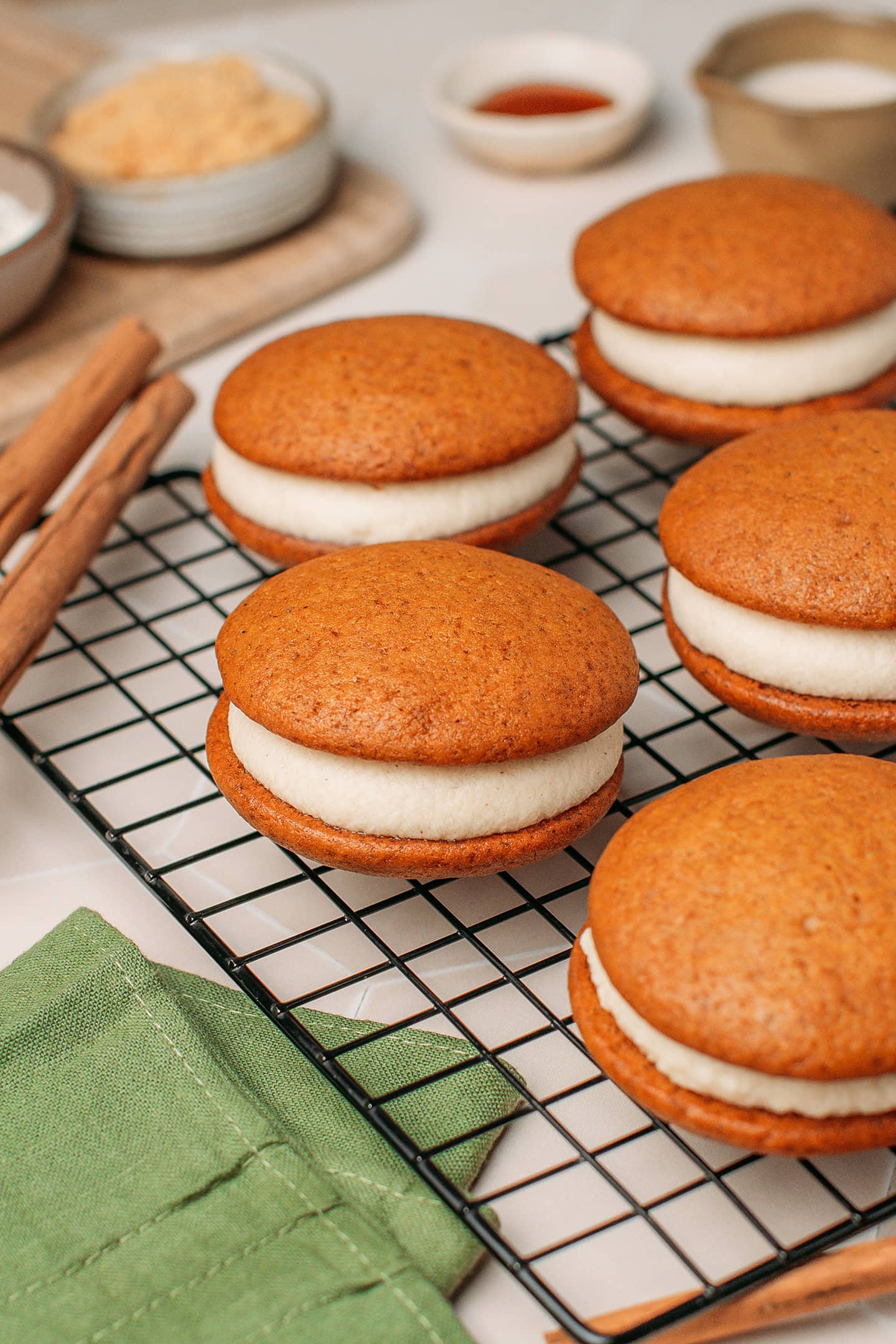Pumpkin whoopie pies on a cooling rack.