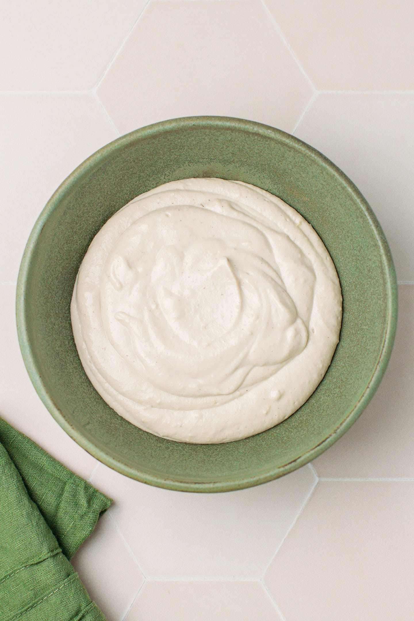Cashew cream filling in a green bowl.
