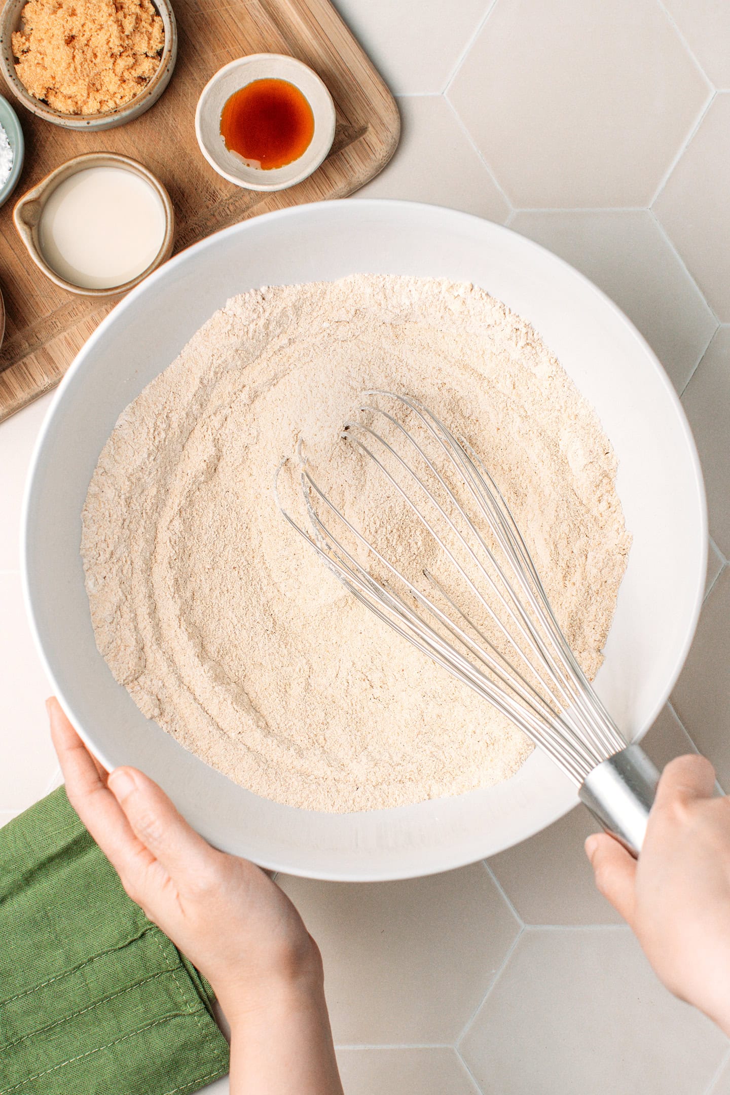 Whisking dry ingredients in a bowl.