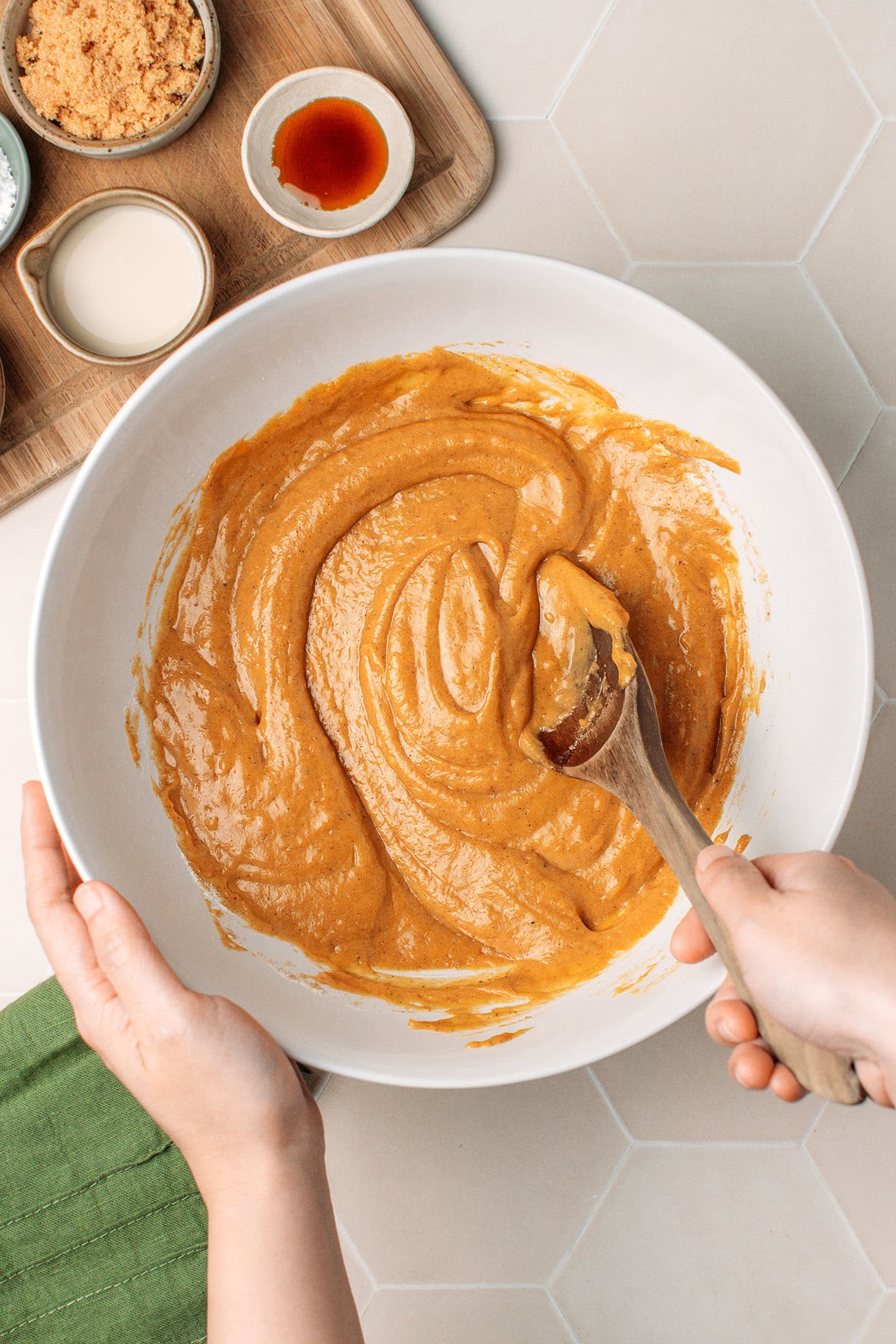 Mixing a pumpkin cake batter in a mixing bowl.