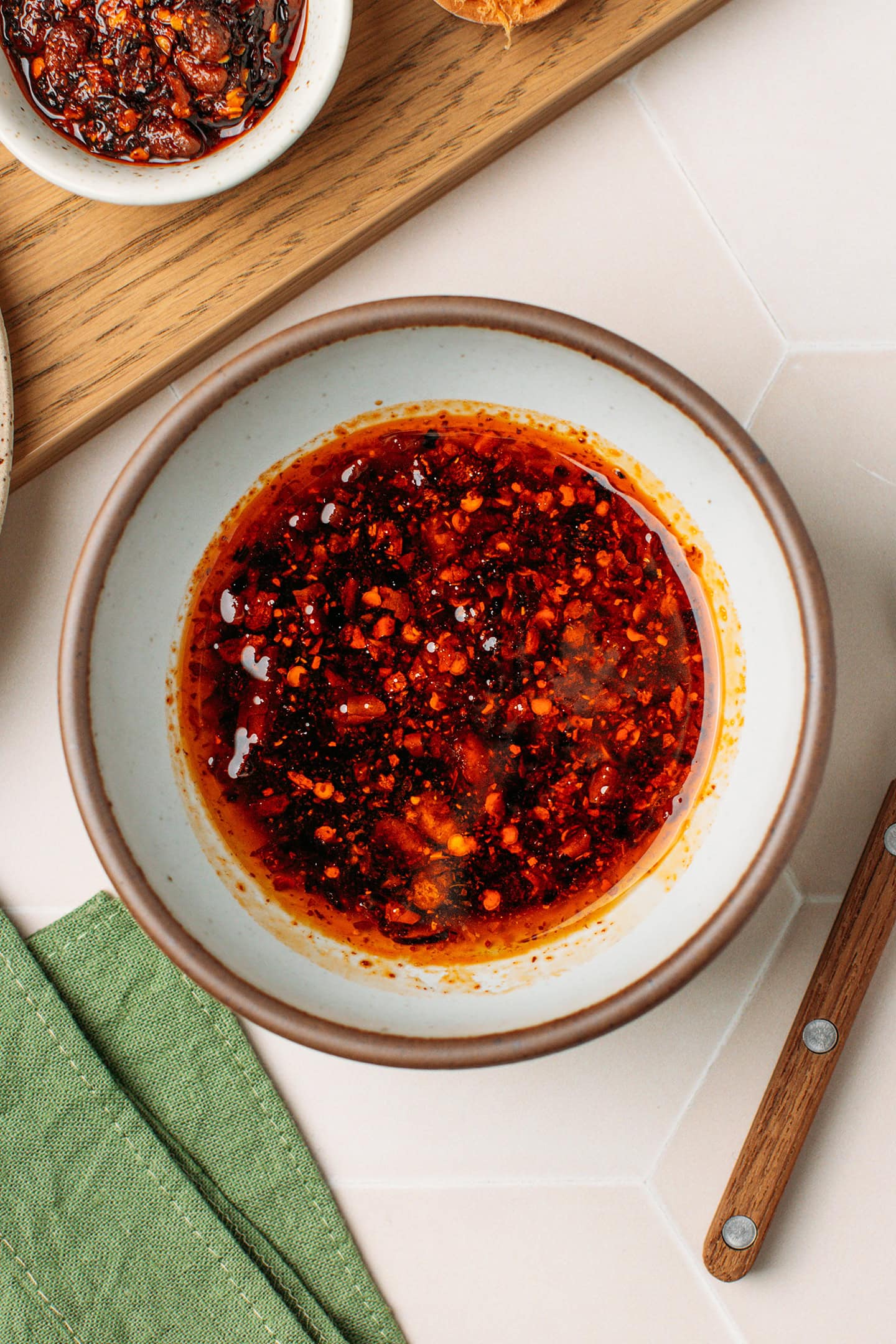 Chili crisp, soy sauce, maple syrup, and vegan oyster sauce in a small bowl.