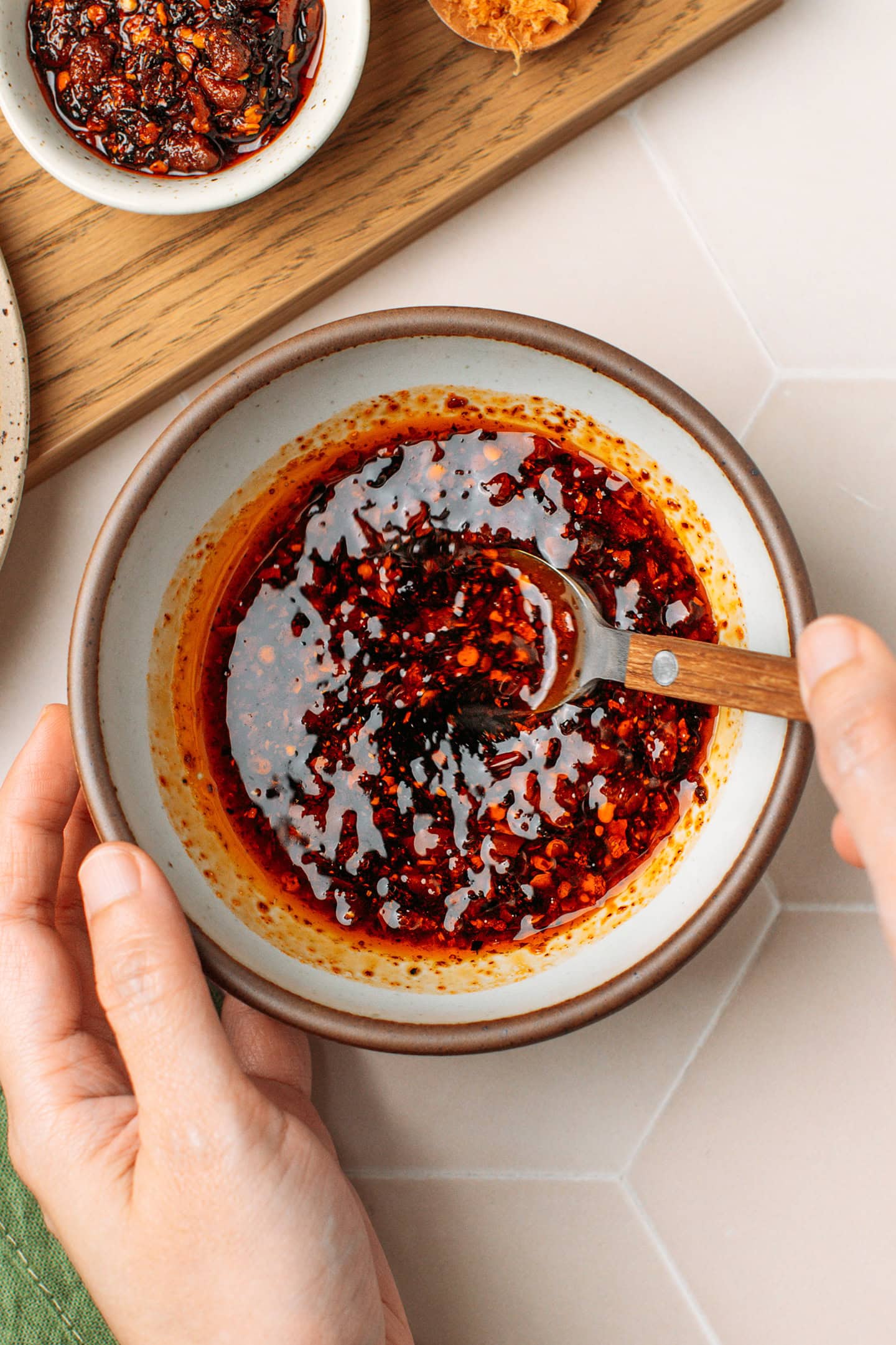 Mixing chili crisp sauce in a small bowl.