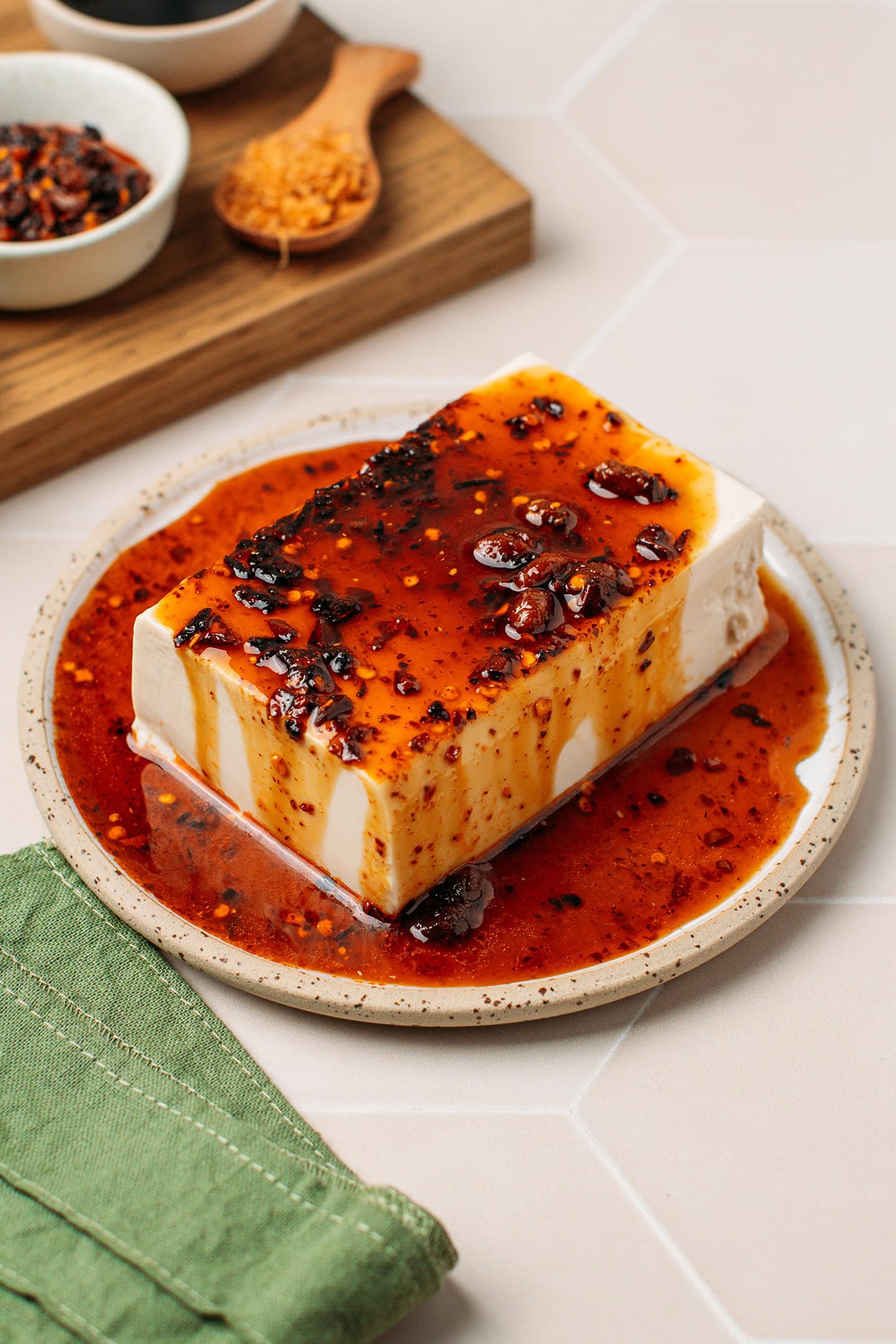 Block of silken tofu coated with chili crisp sauce.