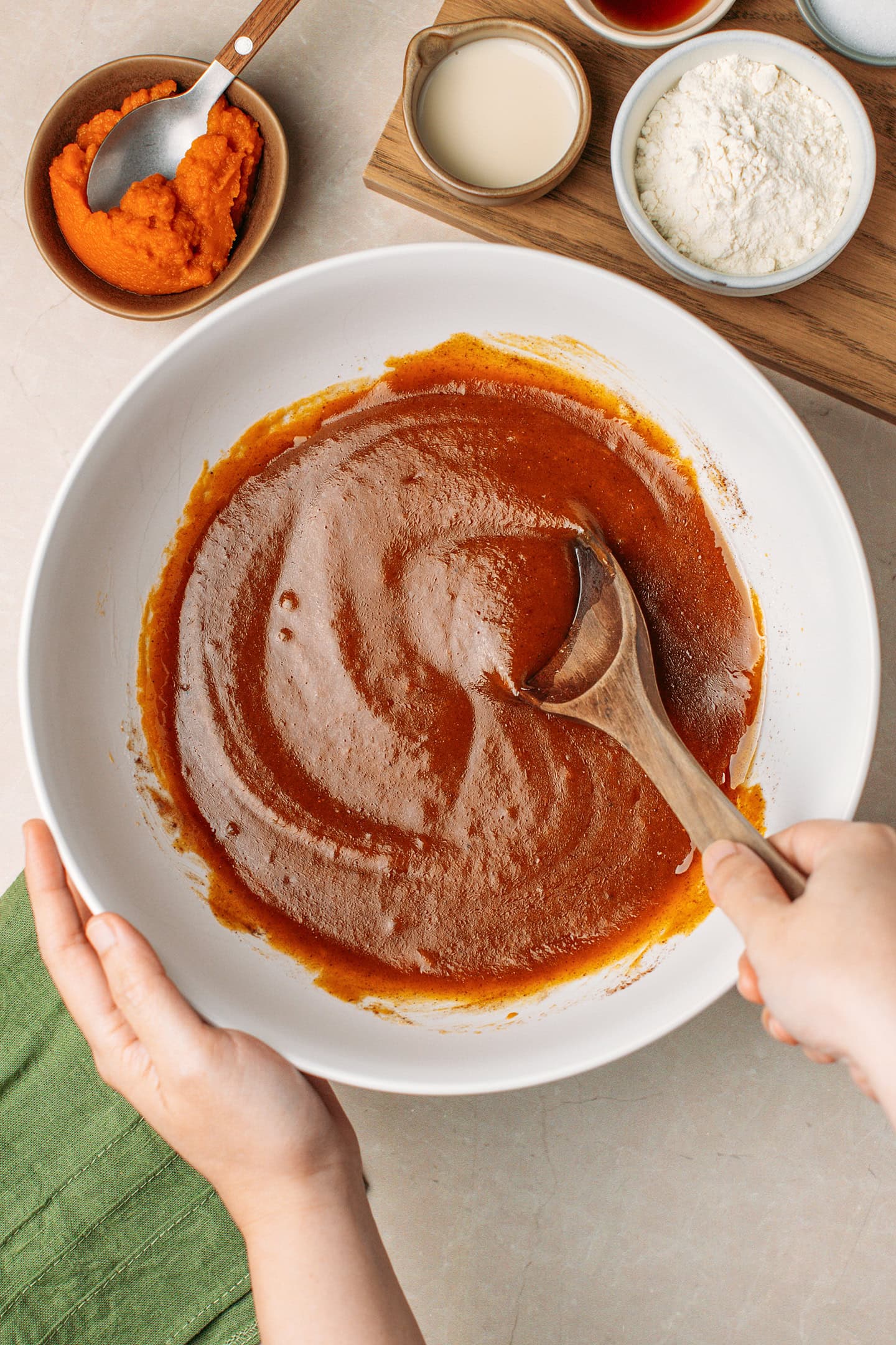 Mixing pumpkin purée with sugar and spices.