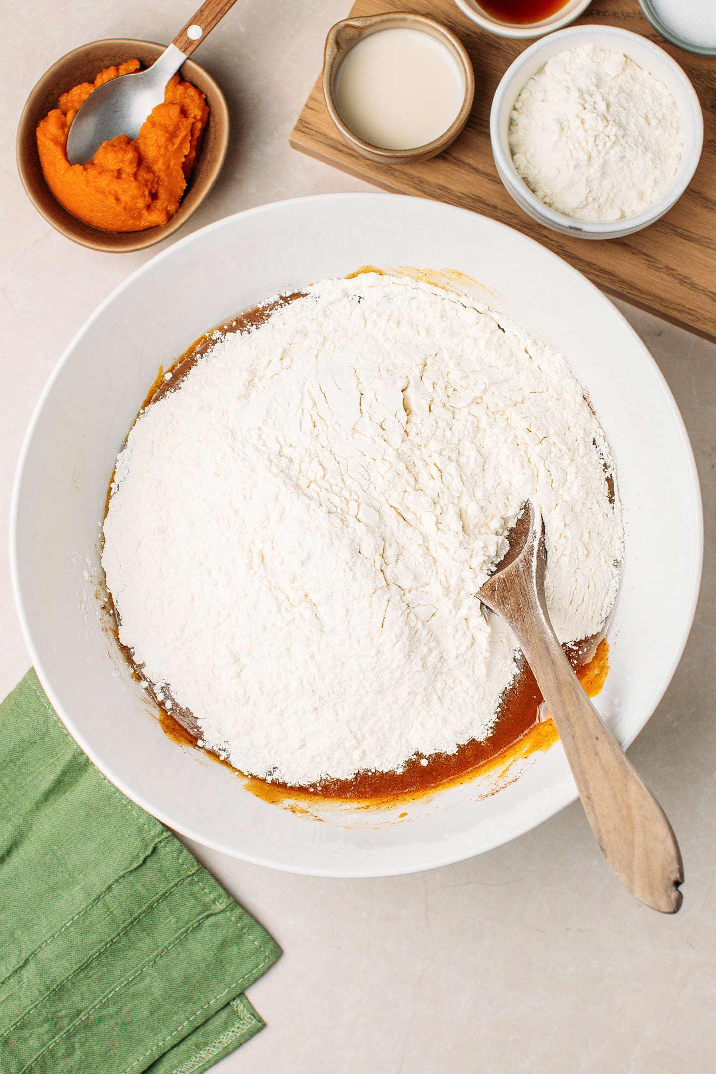 Pumpkin, oil, and flour in a bowl.